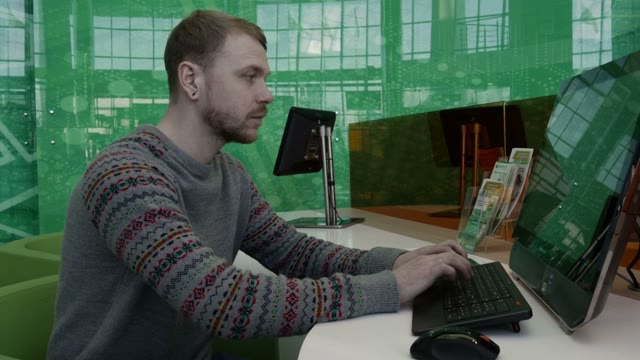 Young Man Working At The Computer In The Office