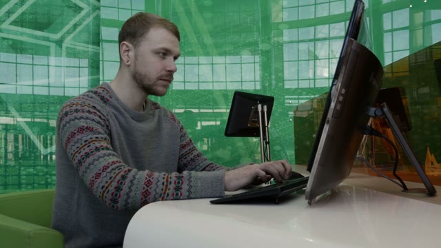 Young Man Working At The Computer In The Office