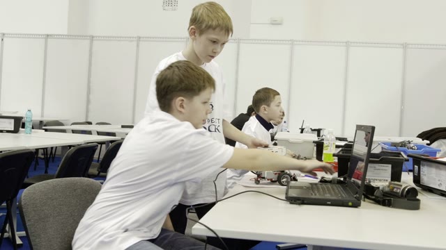 Children Work On A Computer To Create A Robot