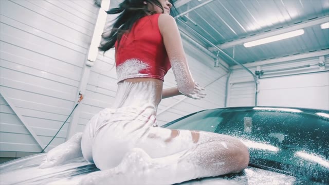 Sexy Woman In A Foam Posing On The Hood Of The Car