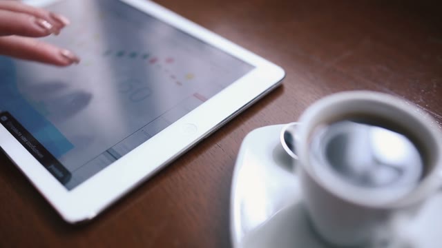 Woman Working With The Tablet In Coffee Shop