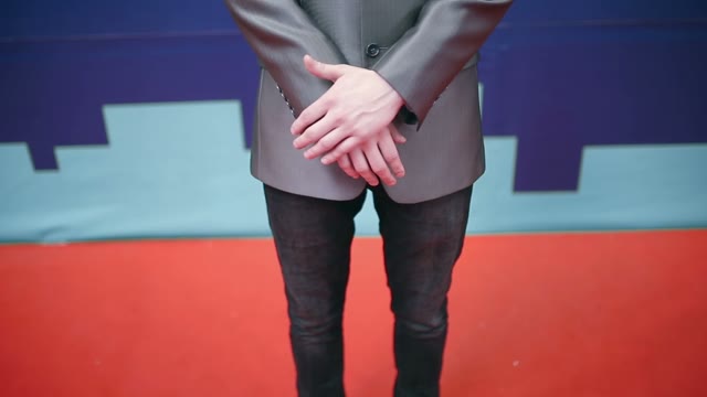 Businessman In A Suit Crosses His Arms