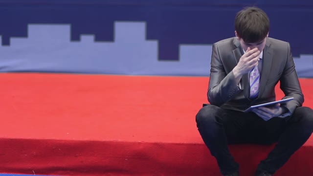 Pensive Businessman Sitting With A Tablet