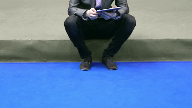 Businessman In A Suit Works With The Tablet