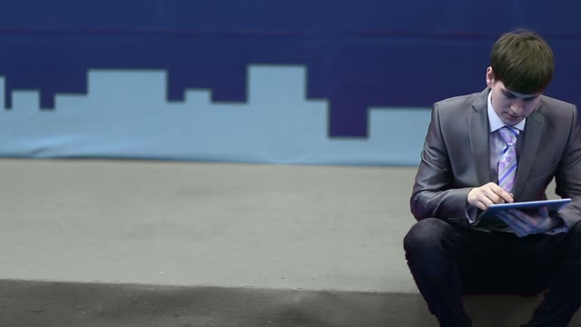 Successful Businessman In A Suit Works With The Tablet