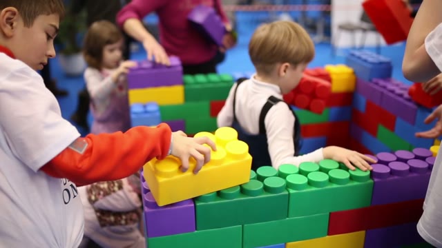 Children Build A House Out Of Lego