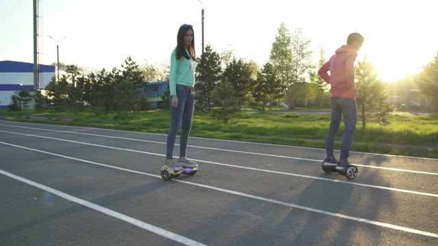 Man And Woman Riding On Hoverboard