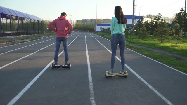 Man And Woman Riding On Hoverboard