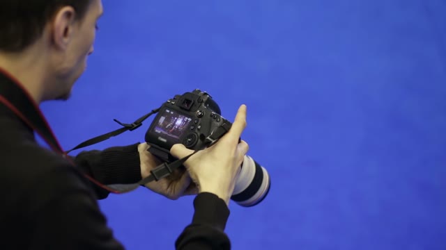 Man Looks Photos Into The Camera