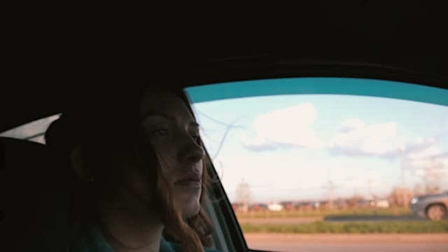 Beautiful Woman Driving A Car In The City