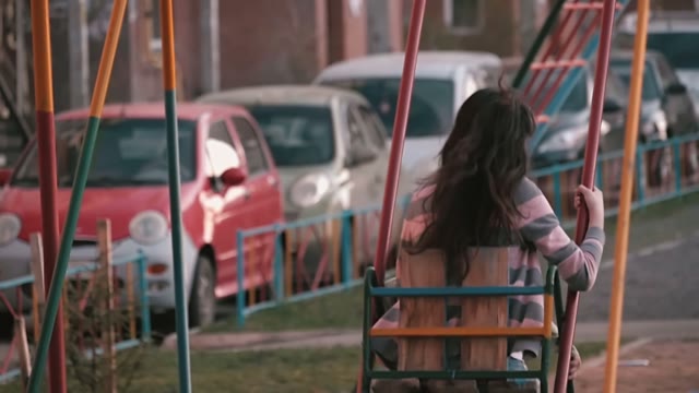 Young Girl Swinging On A Swing