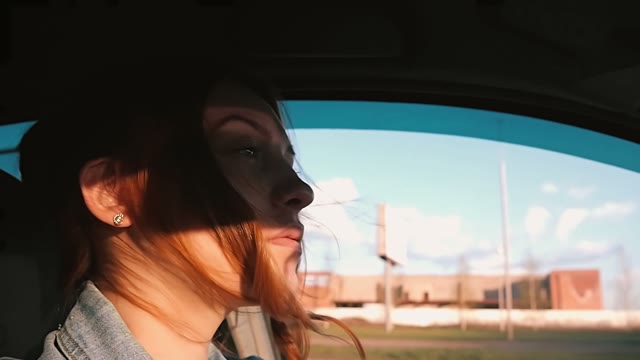 Young Beautiful Woman Driving A Car In The City