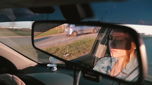 Young Woman Driving A Car In The City