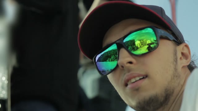 The Man With Glasses Is Watching The Competition And Smiling