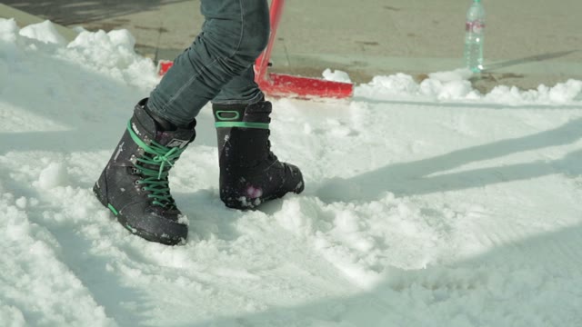 Young Man Throwing Snow Shovel