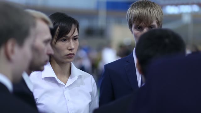 Group Of People In Business Suits Discussing Something