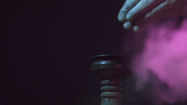 Hands Strew Tobacco In The Bowl Of A Hookah