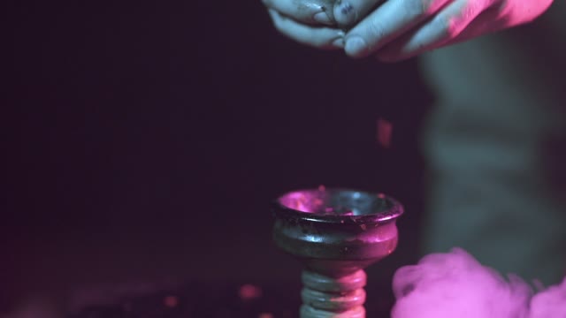 Hands Strew Tobacco In The Chillum Close-up