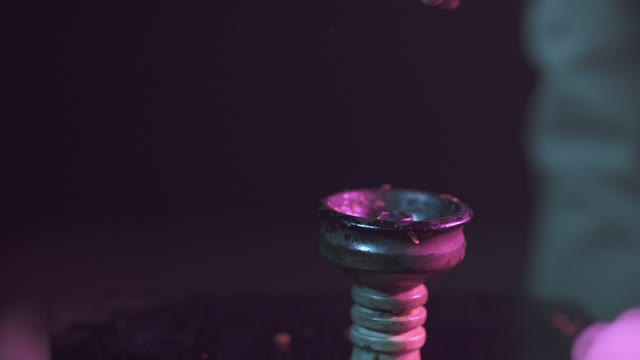 Hands Strew Tobacco In The Chillum Close-up