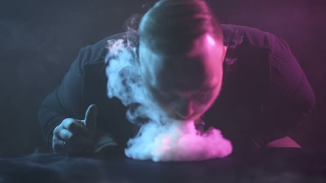 Man Breathes Out Smoke Close-up