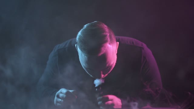 Man Breathes Out Smoke