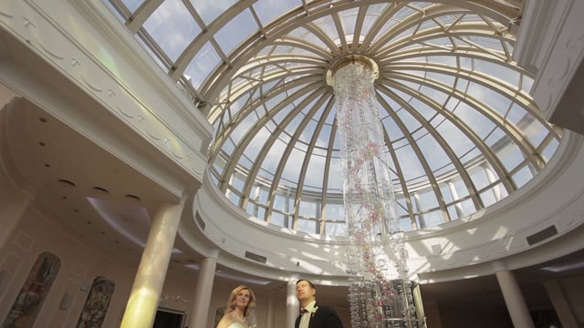 Bride And Groom Are Standing In A Beautiful Building