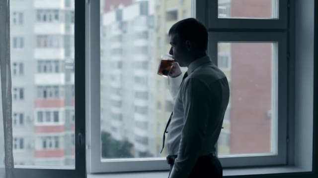 Groom In Shirt Drinks Tea In Front Of The Window