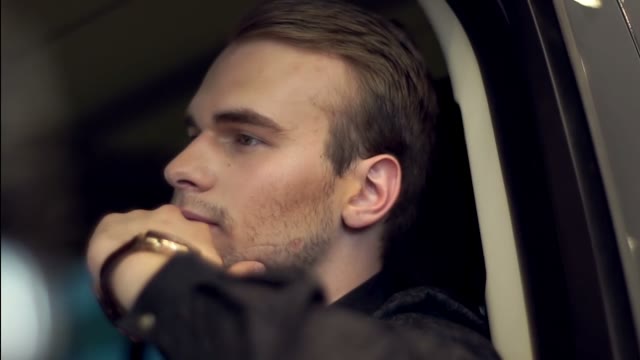 Successful Man Sitting At The Wheel Of An Expensive Car