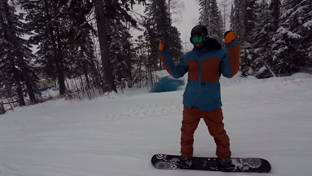 Snowboarder Riding Down The Slope