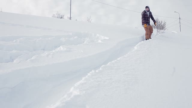 Snowboarder Doing Trick In The Street