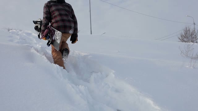 Snowboarder Going Up Hill