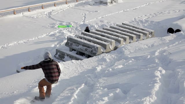 Snowboarder Doing Trick In The Street On Concrete Blocks
