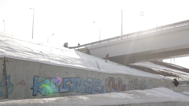 Snowboarder Jumping Over The Street Gap On The Background Of The Sun