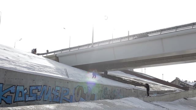 Skier Jumping Over The Street Gap On The Bridge And Sun Background
