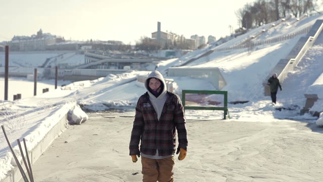 Snowboarder Walking Towards The Camera