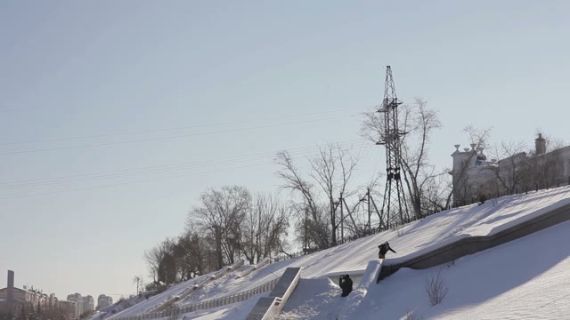 Snowboarder Doing A Slide Trick On A Ledge In The Street