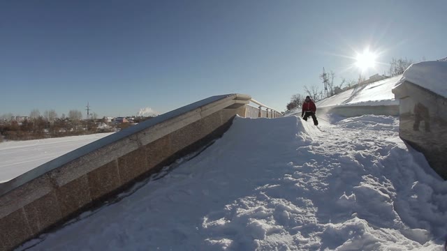 Skier Doing A Slide Trick On A Ledge In The Street And Falls