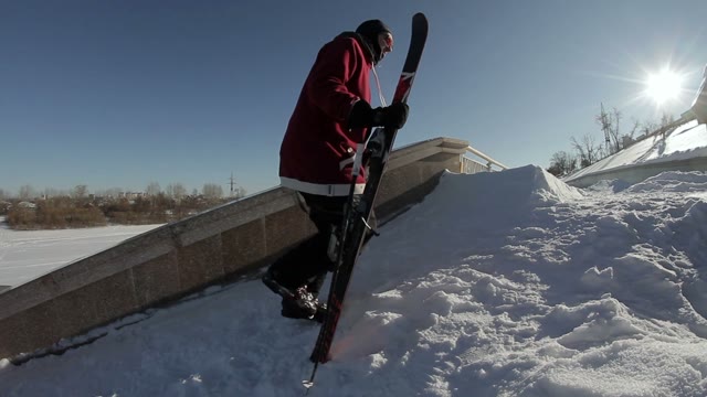 Skier Goes Near The Street Ladge On The Sun Background