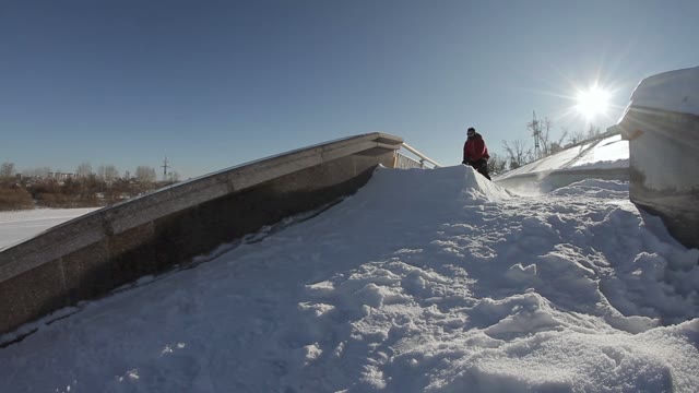 Skier Doing A Slide Trick On A Ledge In The Street
