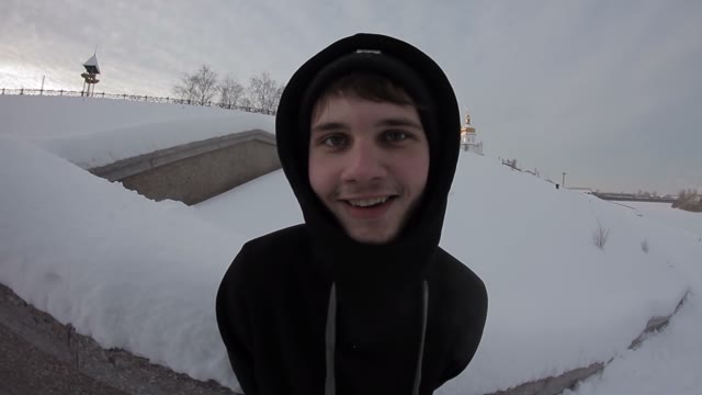 A Young Boy Looks At The Camera And Smiling