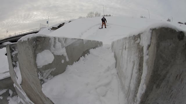 Snowboarder Doing Trick In The Street On Concrete Blocks