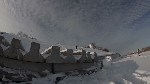 Snowboarder Doing Trick On Concrete Blocks In The Street