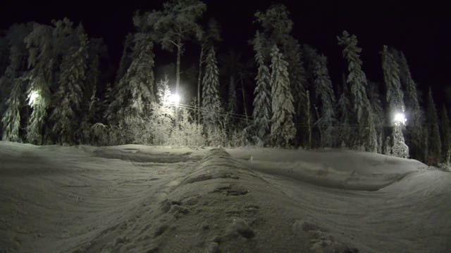 Snowboarder Doing A Stunt In The Night Snowpark