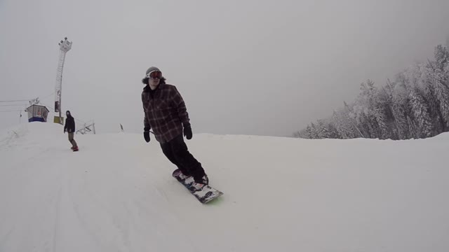 Snowboarder Riding Down The Mountain