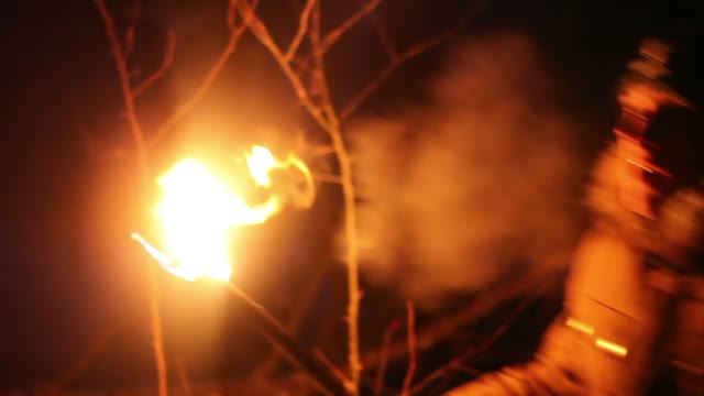 The Young Man Looks Around With The Torch At Night In The Winter Forest
