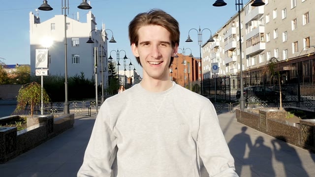 Young Man Smiles And Throws A Skateboard In Hands