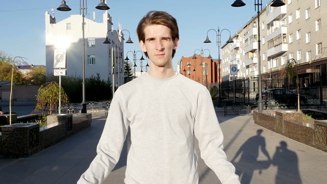 Young Man Smiles And Throws A Skateboard In Hands