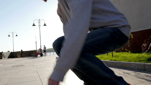 Skateboarder Does Trick At Sunset
