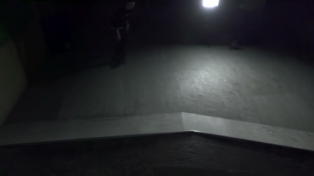 Skateboarder Riding In The Indoor Park