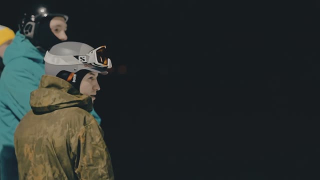 Snowboarders Watching Ride Friends On A Slope